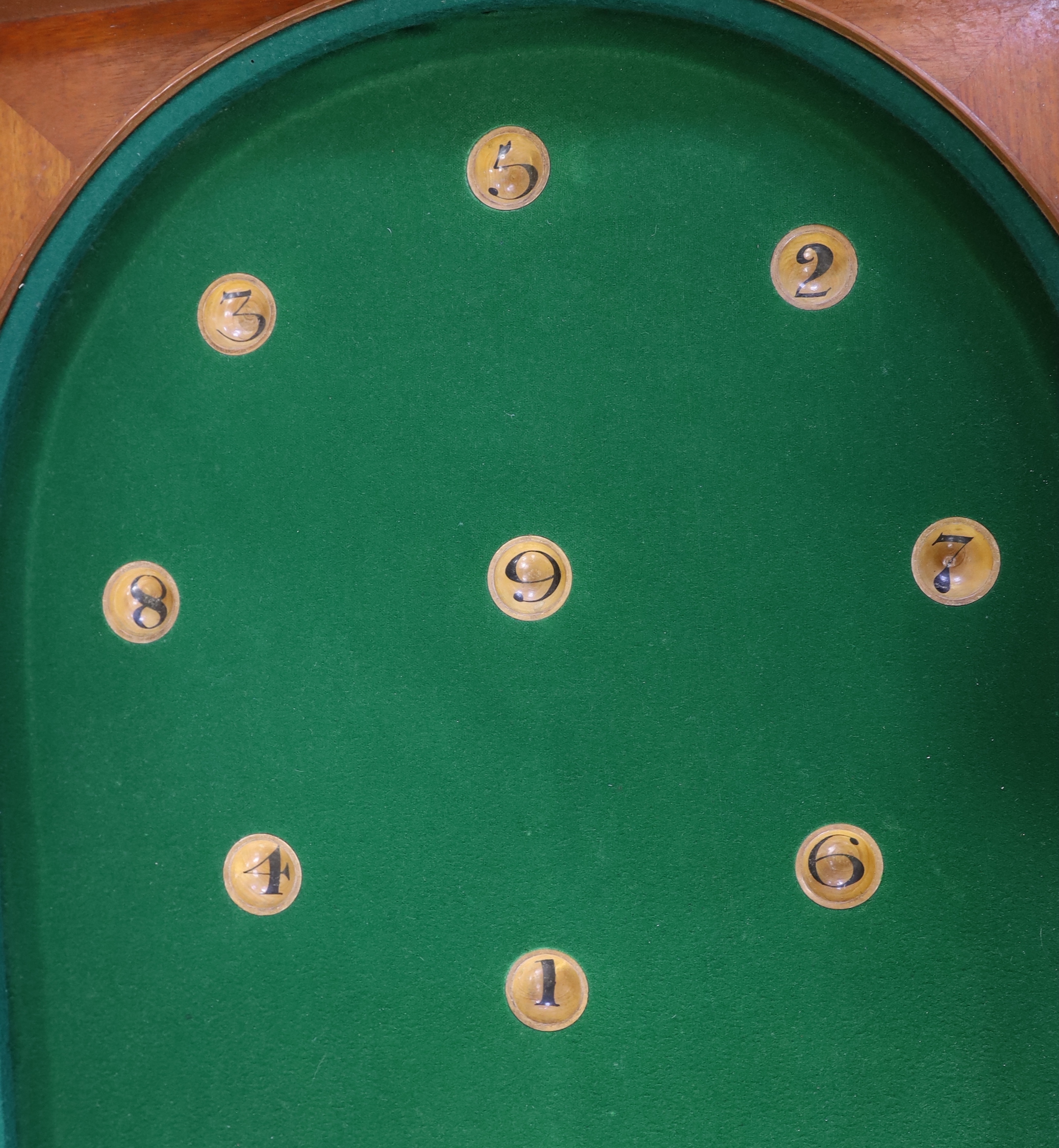 A Victorian folding cased bagatelle board, green baize interior with markers and two cues, 223.5cm open